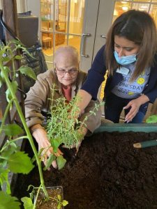 Alzheimer's Patient with Caregiver working with plants