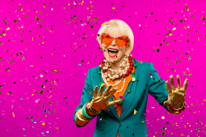 Senior woman partying as confetti is falling