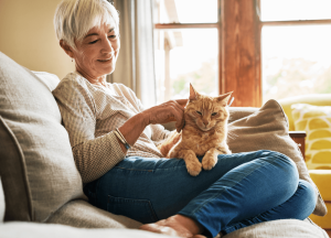 Woman with cat on couch