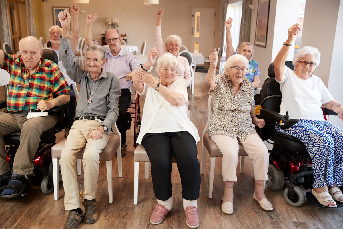 Group of senior people at an assisted living | The Hampton at Meadows Place Group of happy older adults sitting together at a senior living program's class.