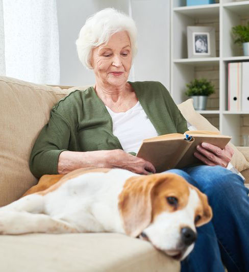 older-adult-reading-with-a-dog