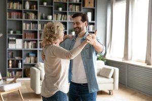Adult son dancing with her mom
