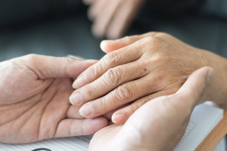 Woman holding a senior's hand