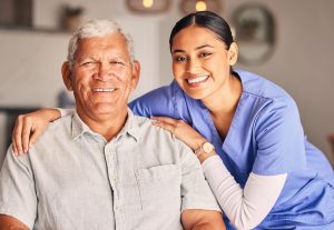 Smiling caregiver hugging an older adult