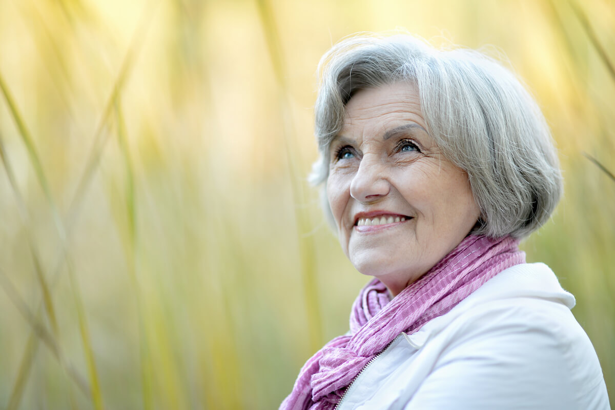 Smiling older woman feeling grateful
