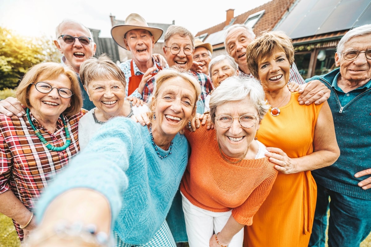 Group of older adults in a senior living community taking a selfie together