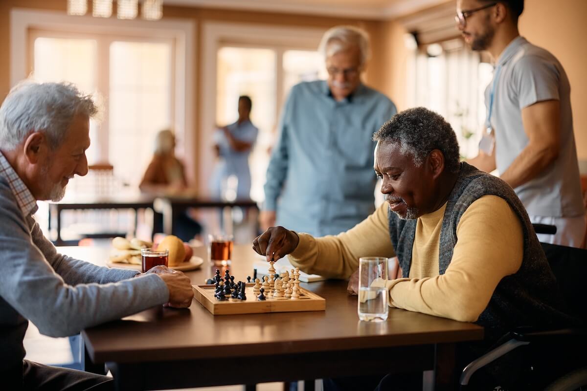 Older men playing chess in a community setting