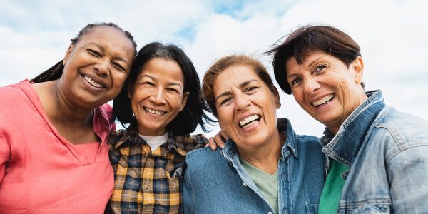 Group of multi-cultural friends taking a picture together.