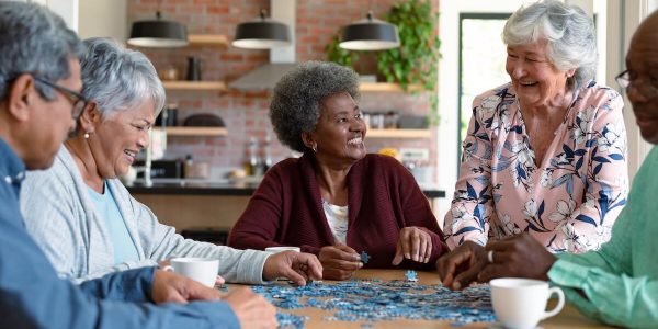 Group of happy seniors gathered in a table.